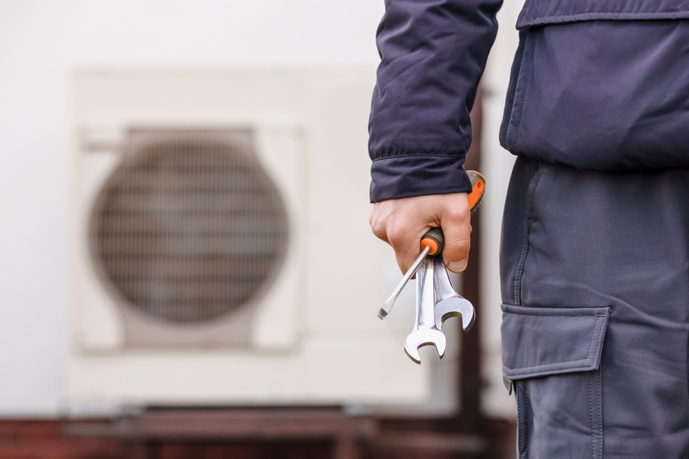 Heat,Pump,Heating,System,Installing,And,Maintenance.,Worker,Hand,With